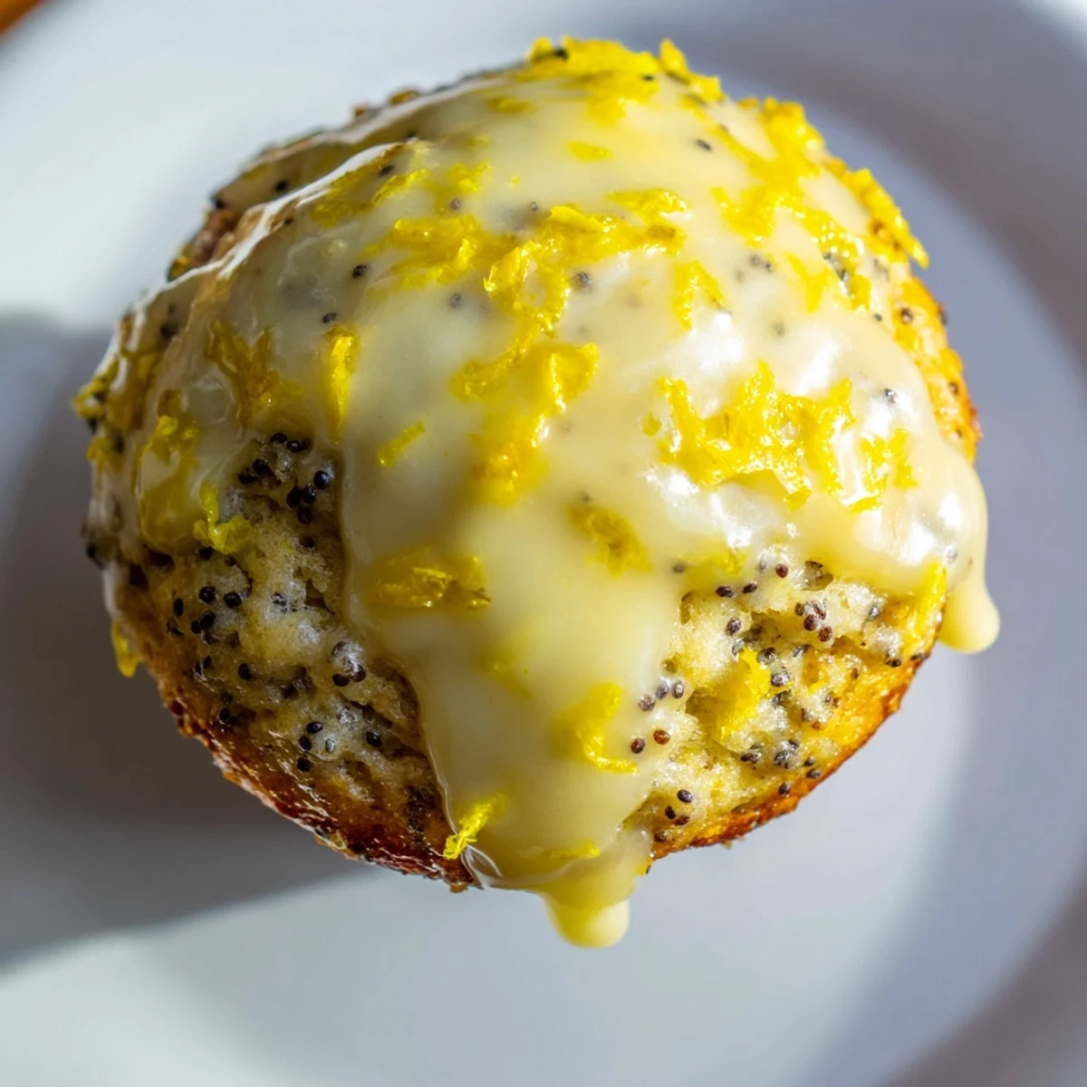 Fluffy baked Lemon Poppy Seed Muffins, showcasing a vibrant lemon zest, ready to be enjoyed.