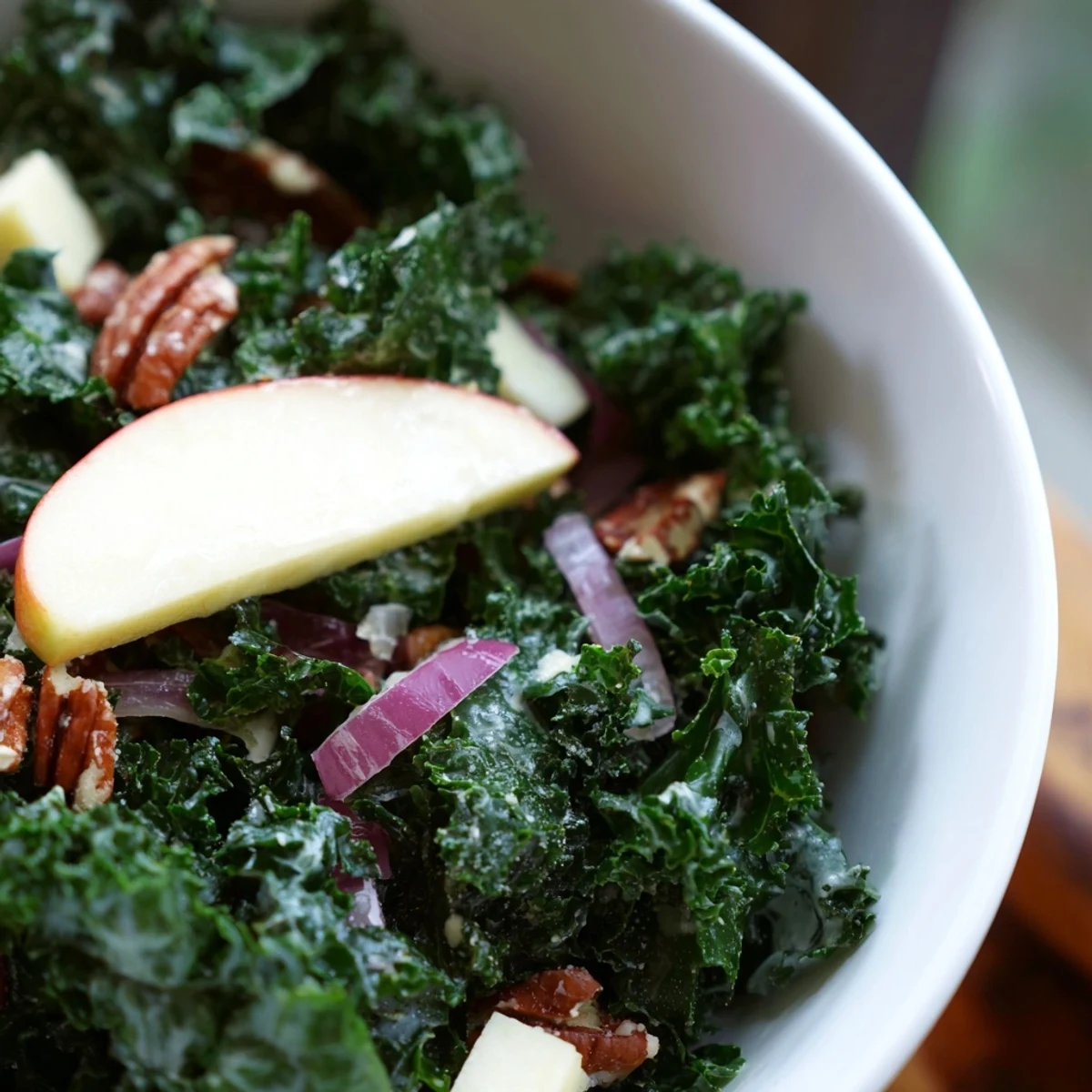 Freshly massaged kale for this Winter Kale Salad with Apple and Sharp Cheddar is tossed with crisp apple slices, sharp cheddar cubes, and crunchy toasted pecans, all glistening with a light apple cider vinaigrette.