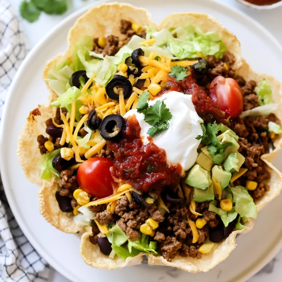 Golden crispy flour tortilla shell filled with seasoned ground beef, black beans, corn, and shredded cheddar cheese.