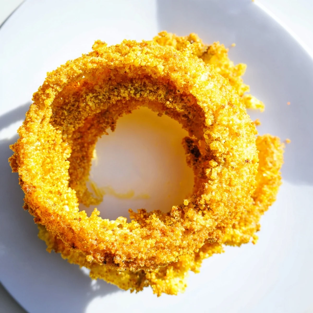 Golden Crispy Baked Onion Rings stacked high, showcasing a crunchy texture perfect for dipping into ranch.