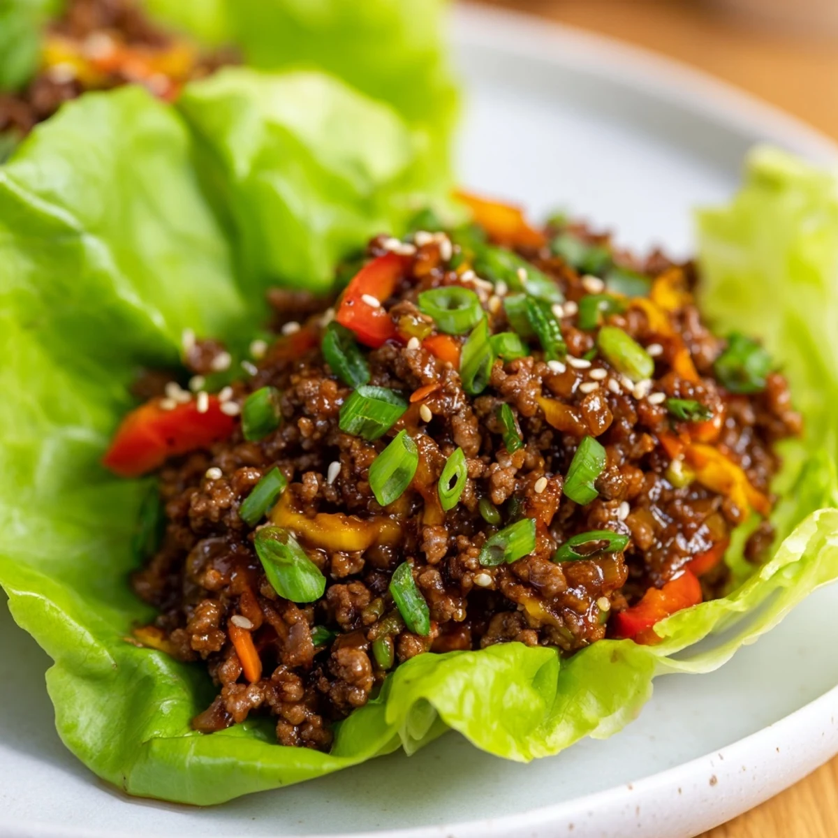 Freshly sautéed savory ground beef with crisp diced vegetables nestled in soft butter lettuce leaves.