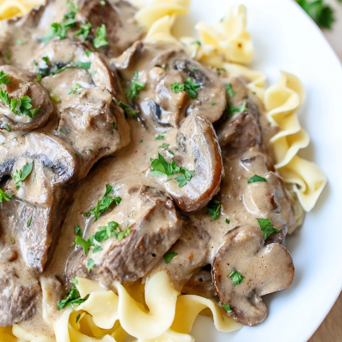 Tender strips of beef and sautéed mushrooms in creamy Beef Stroganoff with Mushroom Gravy served over rice.