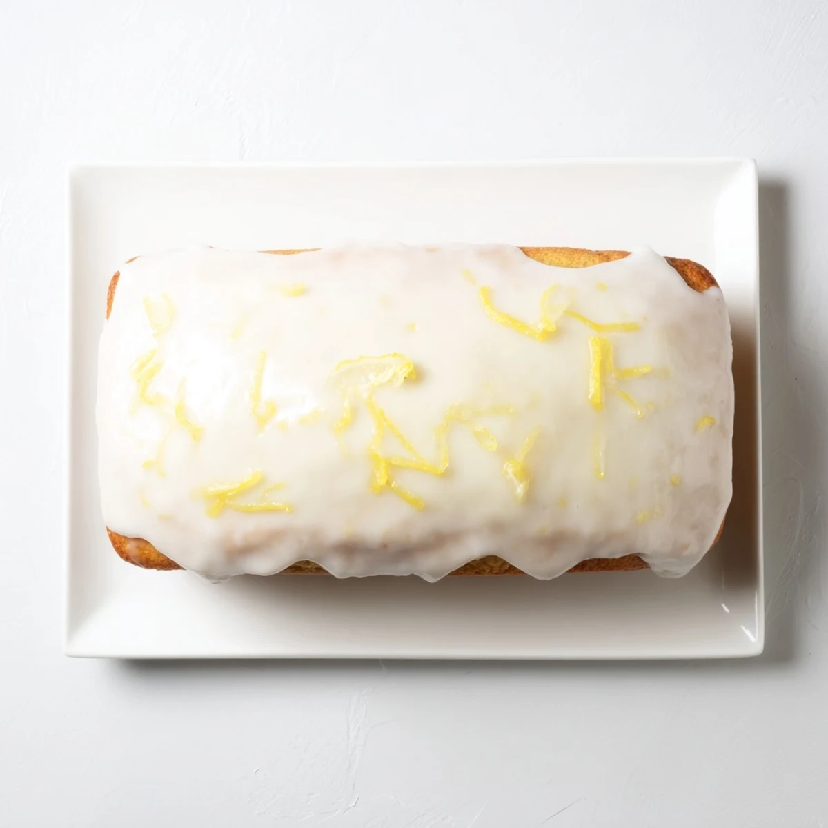 Lemon Loaf Cake with a drizzle of tangy icing, perfect for afternoon tea or a bright dessert.