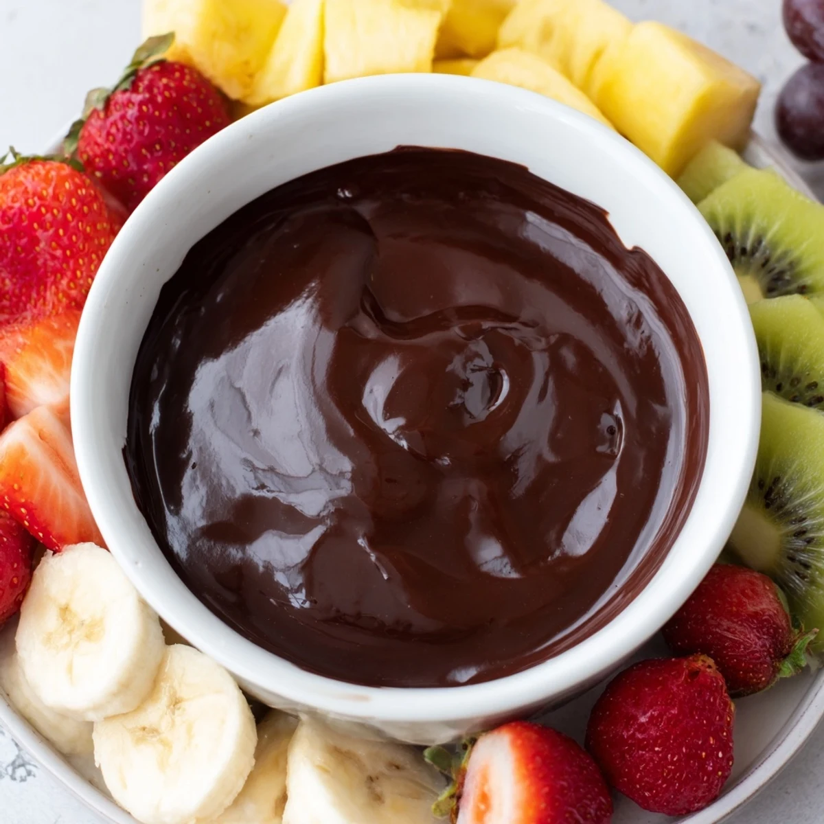 For date night, Romantic Chocolate Fondue with Fruit Platter sits by candlelight, with skewers ready for dipping.