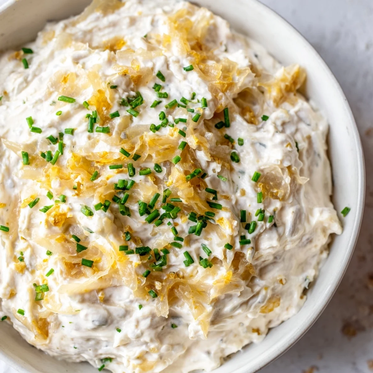 Golden, caramelized onions blended into a creamy Game Day Onion Dip served with sturdy potato chips.