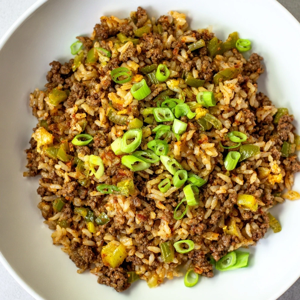 Hearty Cajun Dirty Rice with Ground Beef featuring a savory blend of spices, ground beef, and tender rice in one pan.