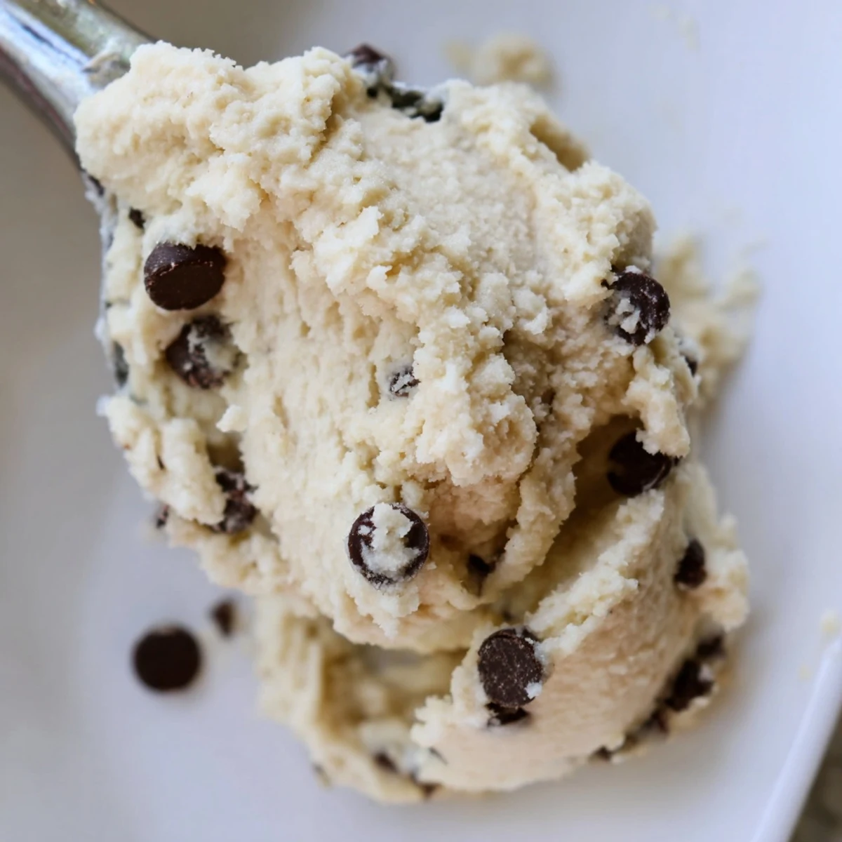 This Edible Keto Cookie Dough is plated for serving, with rich chocolate chips and a keto dessert vibe.