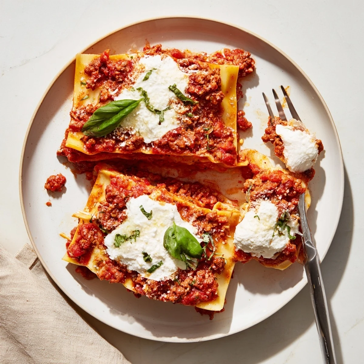 This easy stovetop Cheats Frypan Lasagne shows tender pasta sheets nestled in a rich, hearty tomato sauce with melted cheese.