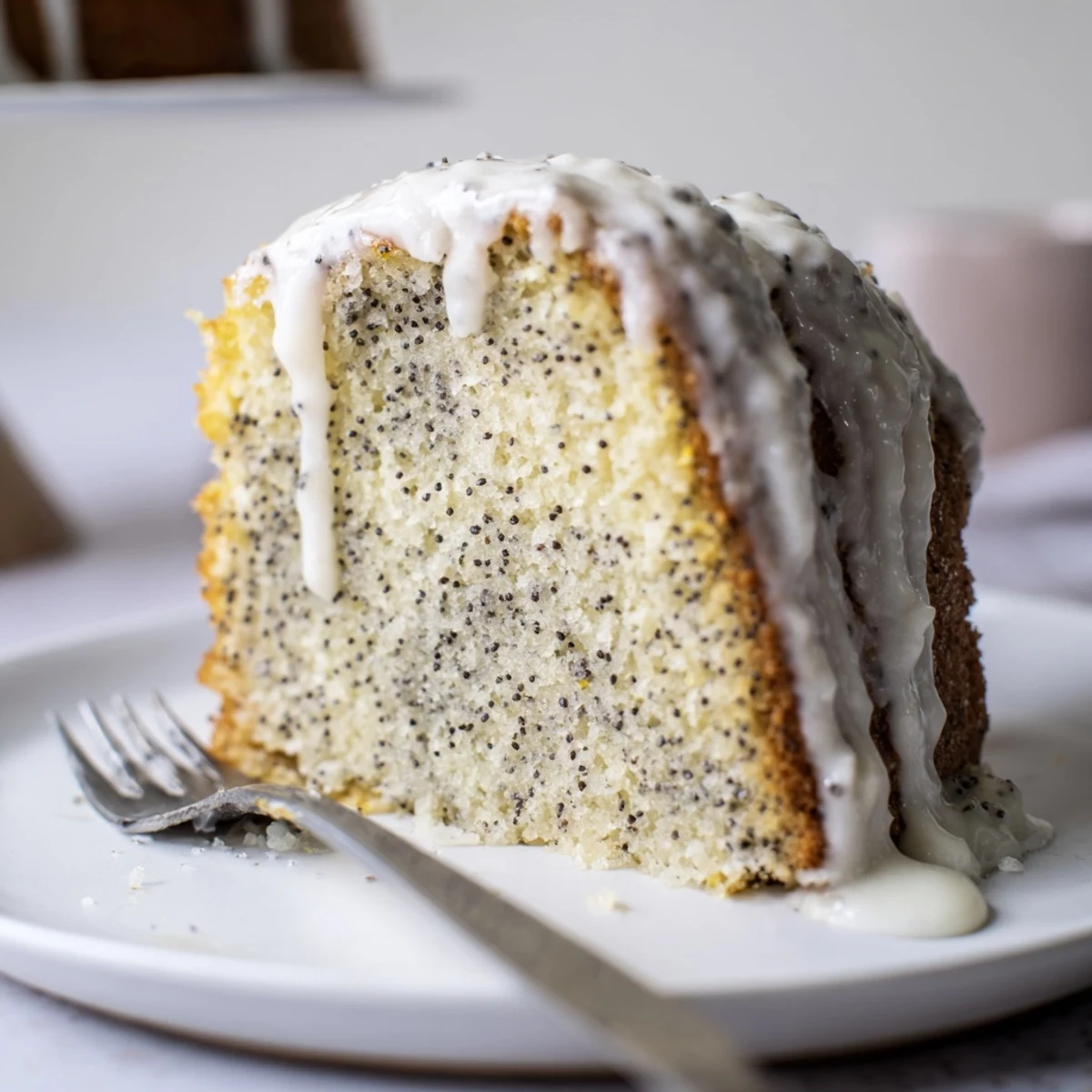 Whole Lemon Poppy Seed Cake in a Bundt pan cooling on a wire rack, perfect for afternoon tea or a refreshing dessert.