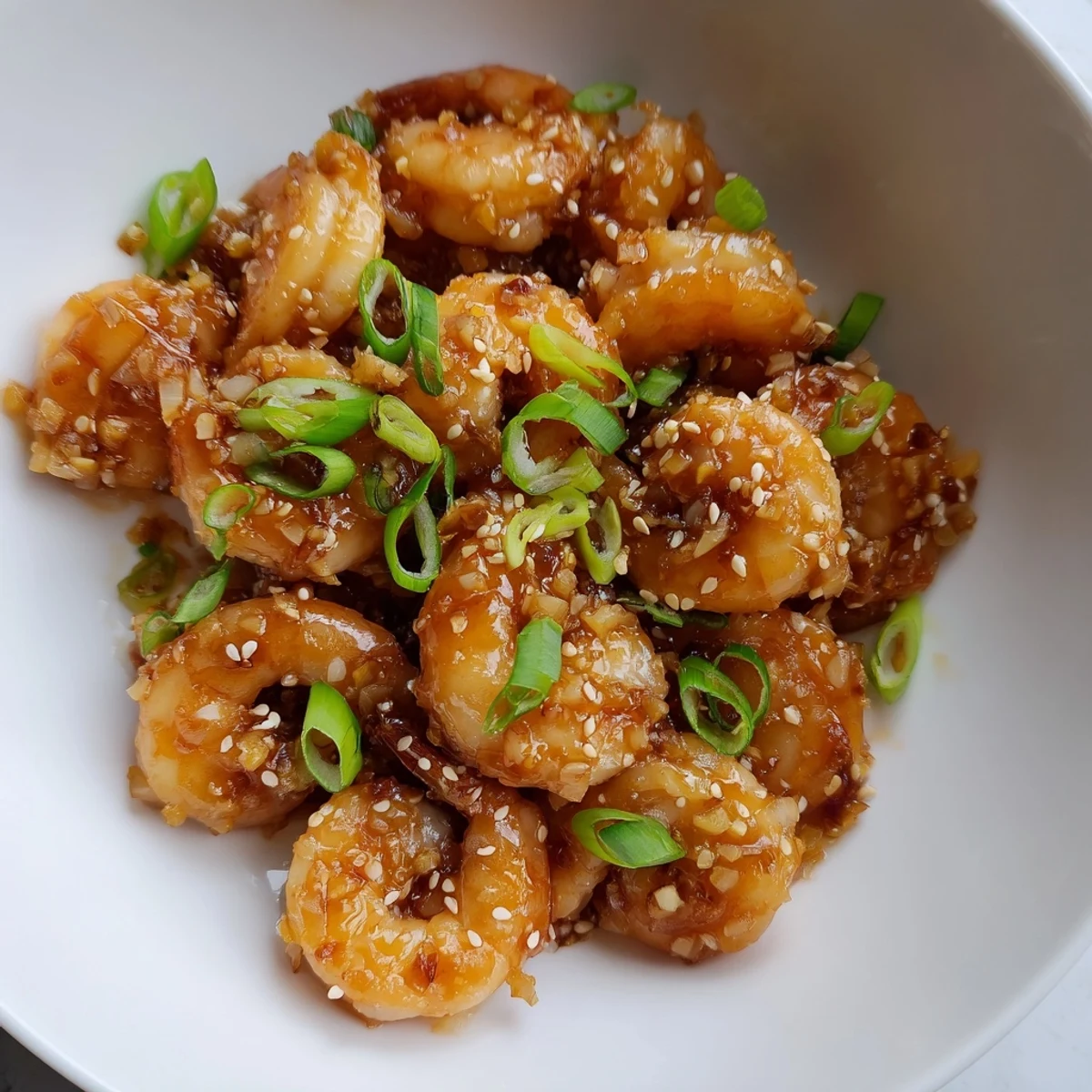 Sizzling High Protein Honey Garlic Shrimp fresh from the skillet, glazed in thick honey garlic sauce and ready to serve.