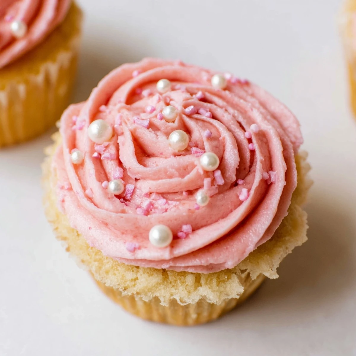 Freshly baked Girl Baby Shower Cupcakes with fluffy pink frosting and baby-themed decorations ready for a celebration.