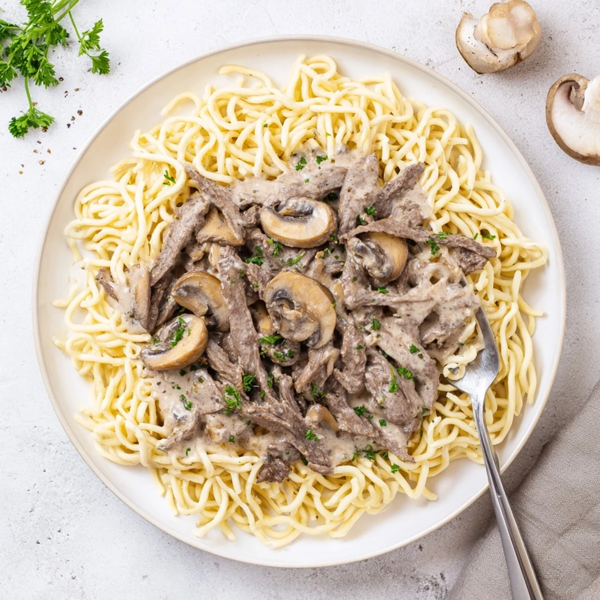 Tender strips of beef and earthy mushrooms swimming in a rich sour cream sauce over pasta