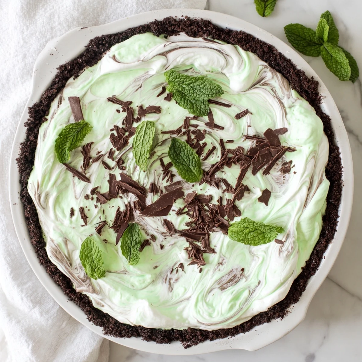 Festive Shamrock Swirl Pie showing swirled green peppermint filling in chocolate cookie crust