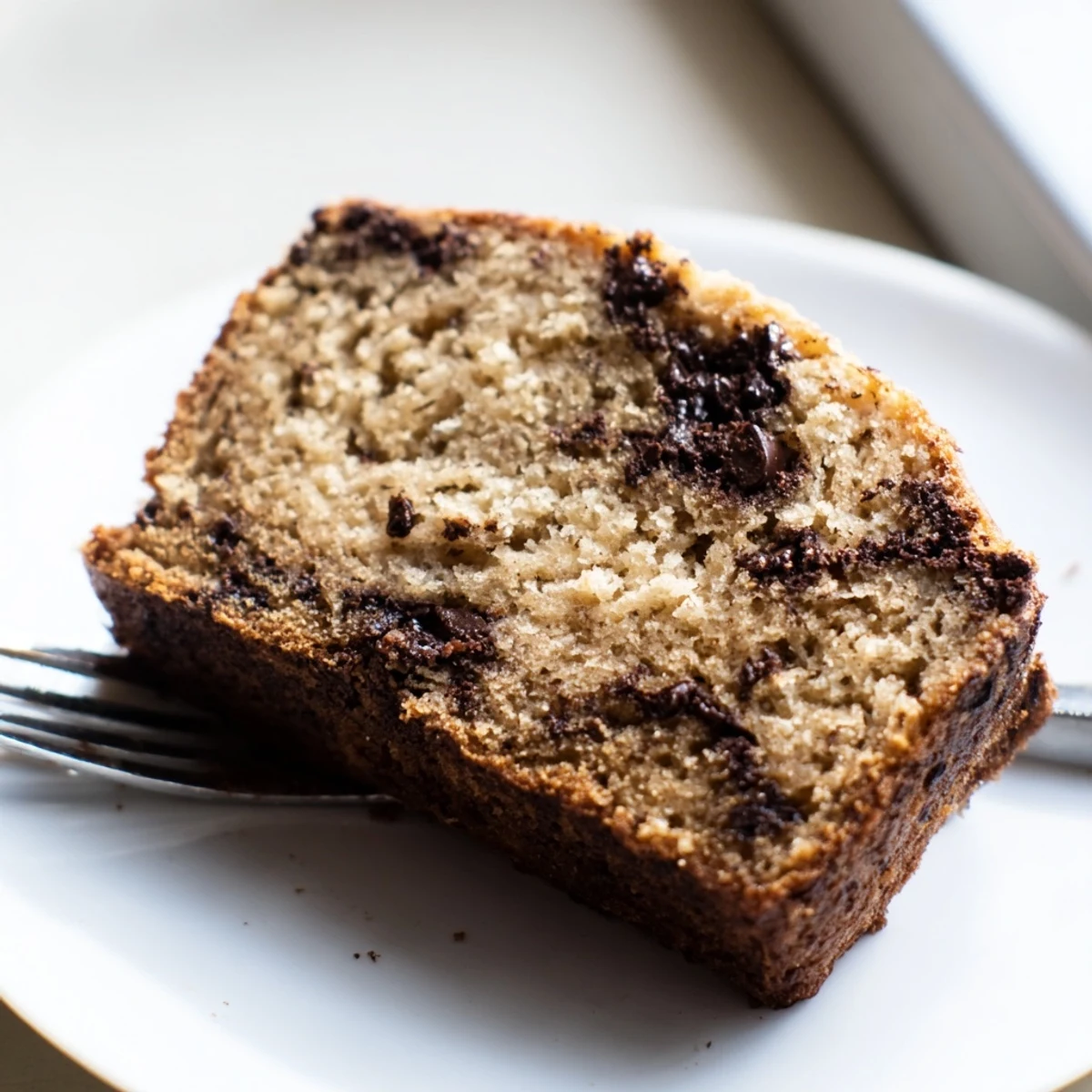 Freshly baked super moist chocolate chip banana bread with chocolate chunks visible throughout
