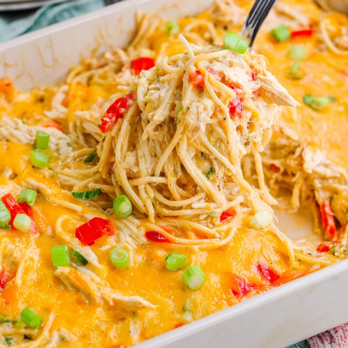 Hearty pasta dish featuring shredded chicken and vegetables in a rich Monterey Jack cheese sauce baked until golden