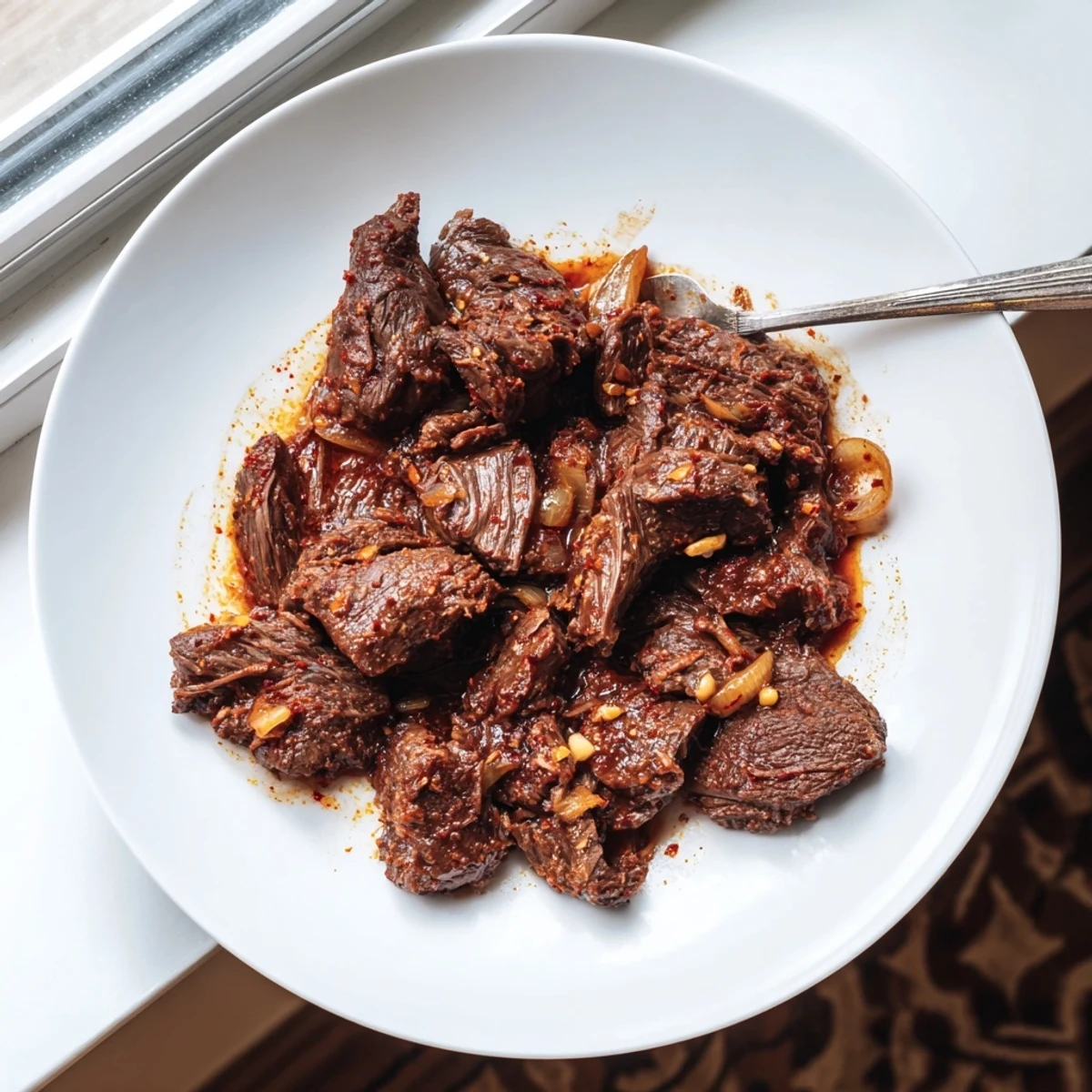 Slow-cooked Crock Pot shredded beef piled high with rich, savory cooking juices
