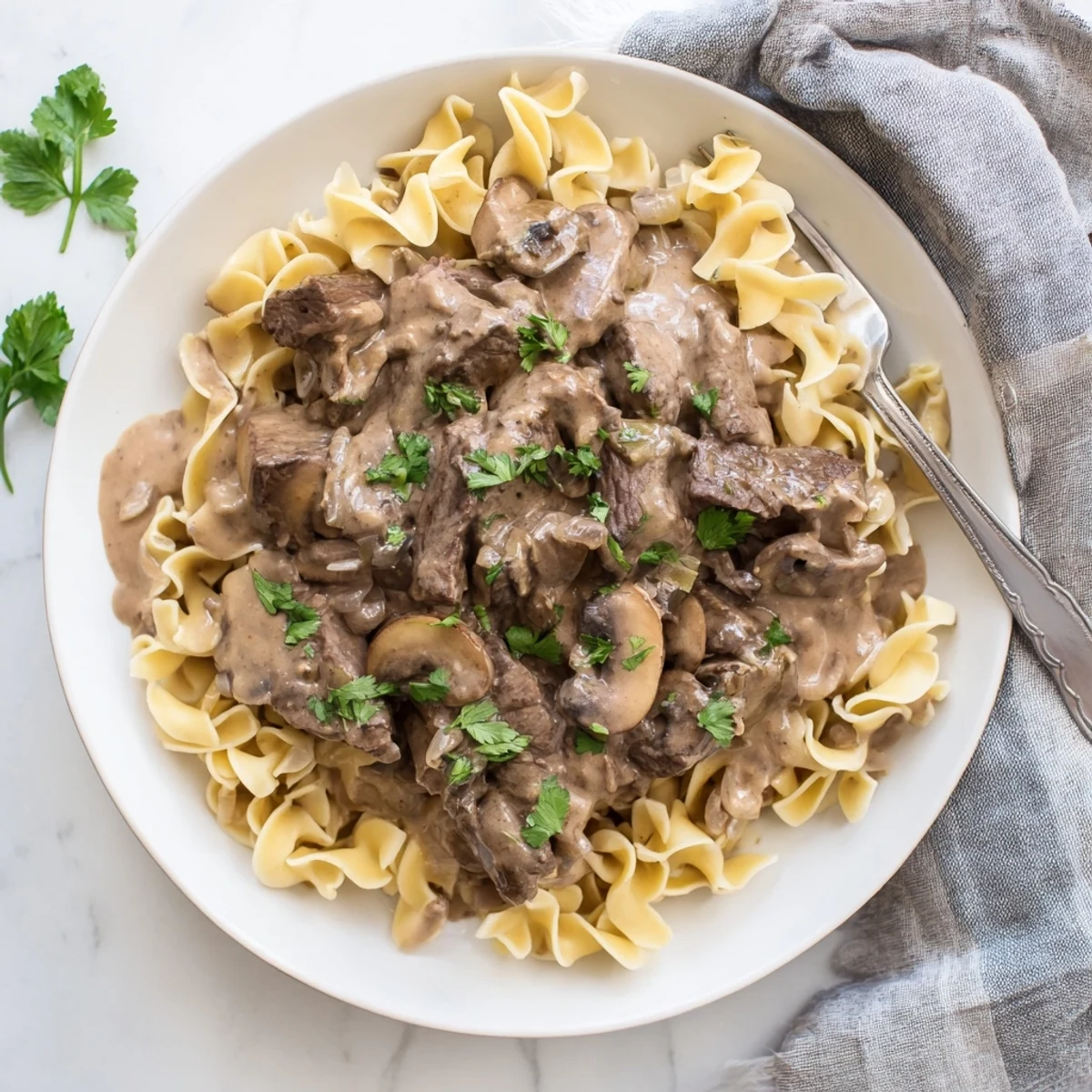Classic beef stroganoff featuring golden mushrooms and savory beef in a velvety white cream sauce