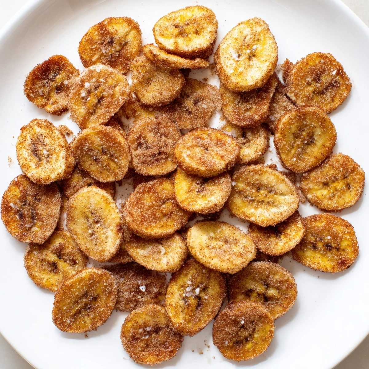 Crispy homemade banana chips coated in sweet cinnamon sugar and air fried to perfection