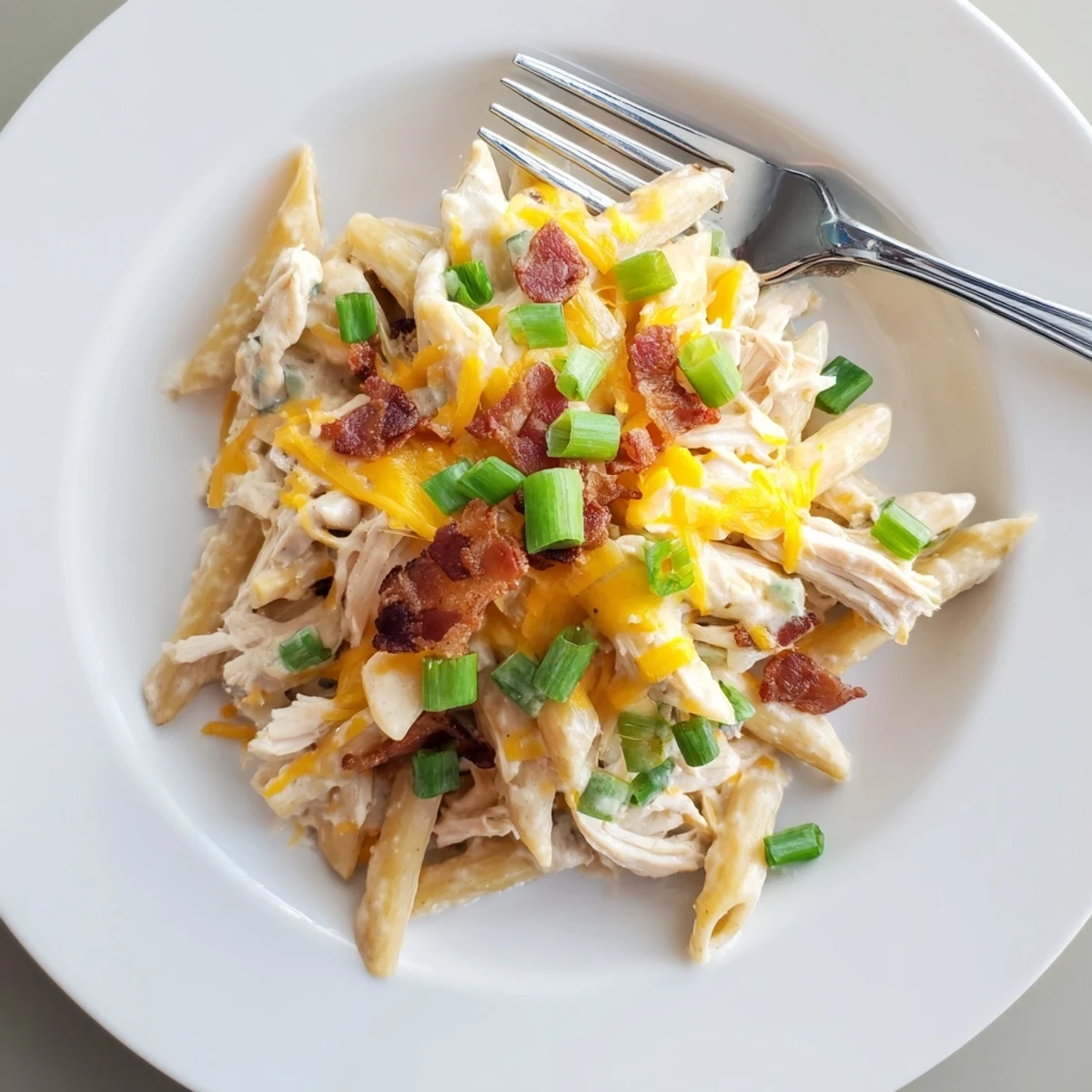 Savory comfort food bowl featuring tender chicken and cheddar cheese over penne pasta