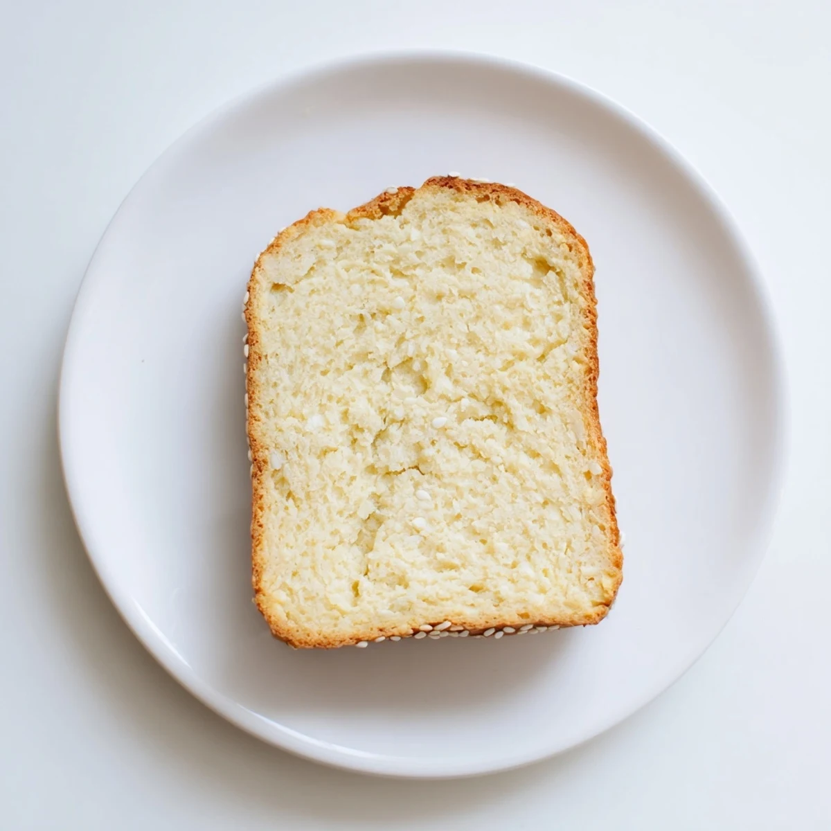 Homemade zero carb yogurt bread slices arranged on cutting board with knife nearby