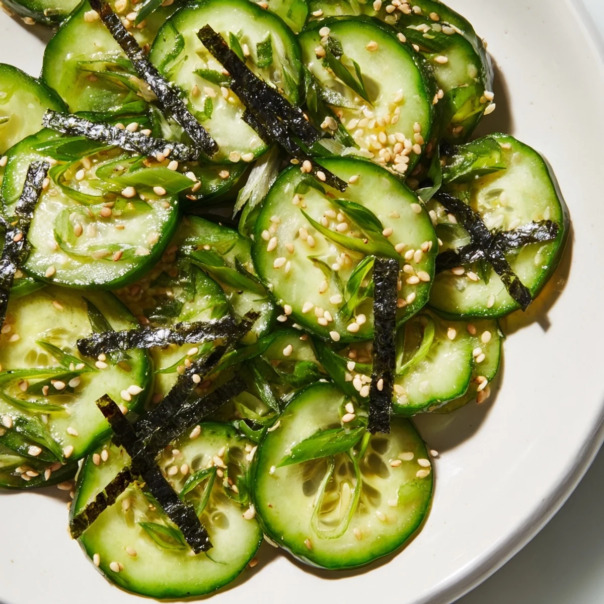 Sushi Cucumber Salad with crisp slices, nori strips, and sesame garnish in tangy dressing