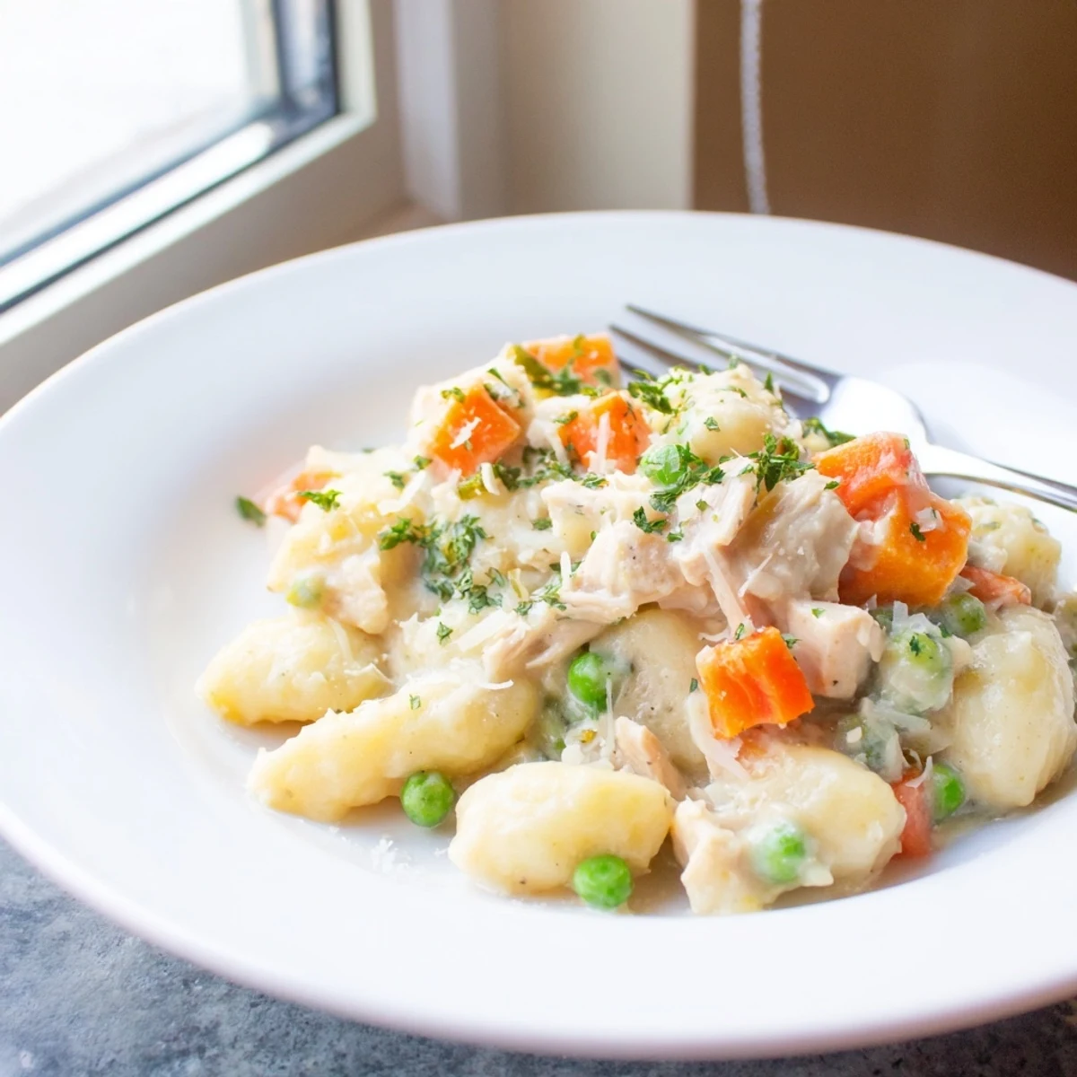 Creamy One Pot Gnocchi Chicken Pot Pie topped with fresh parsley and served warm