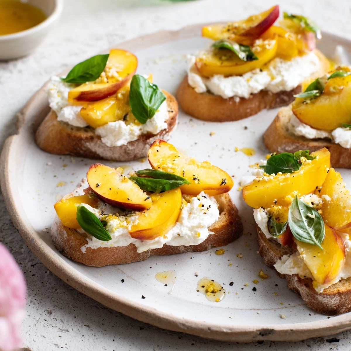 Peach Bruschetta With Whipped Ricotta on toasted baguette, honey drizzle, basil.  