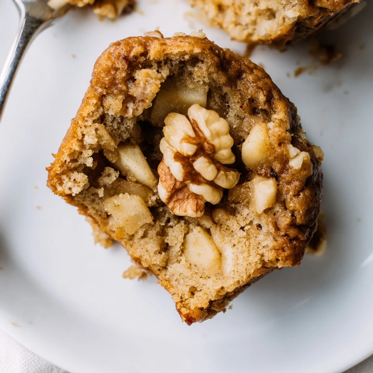 Healthy Apple Cinnamon Greek Yogurt Muffins sliced to show juicy apple pieces, soft interior
