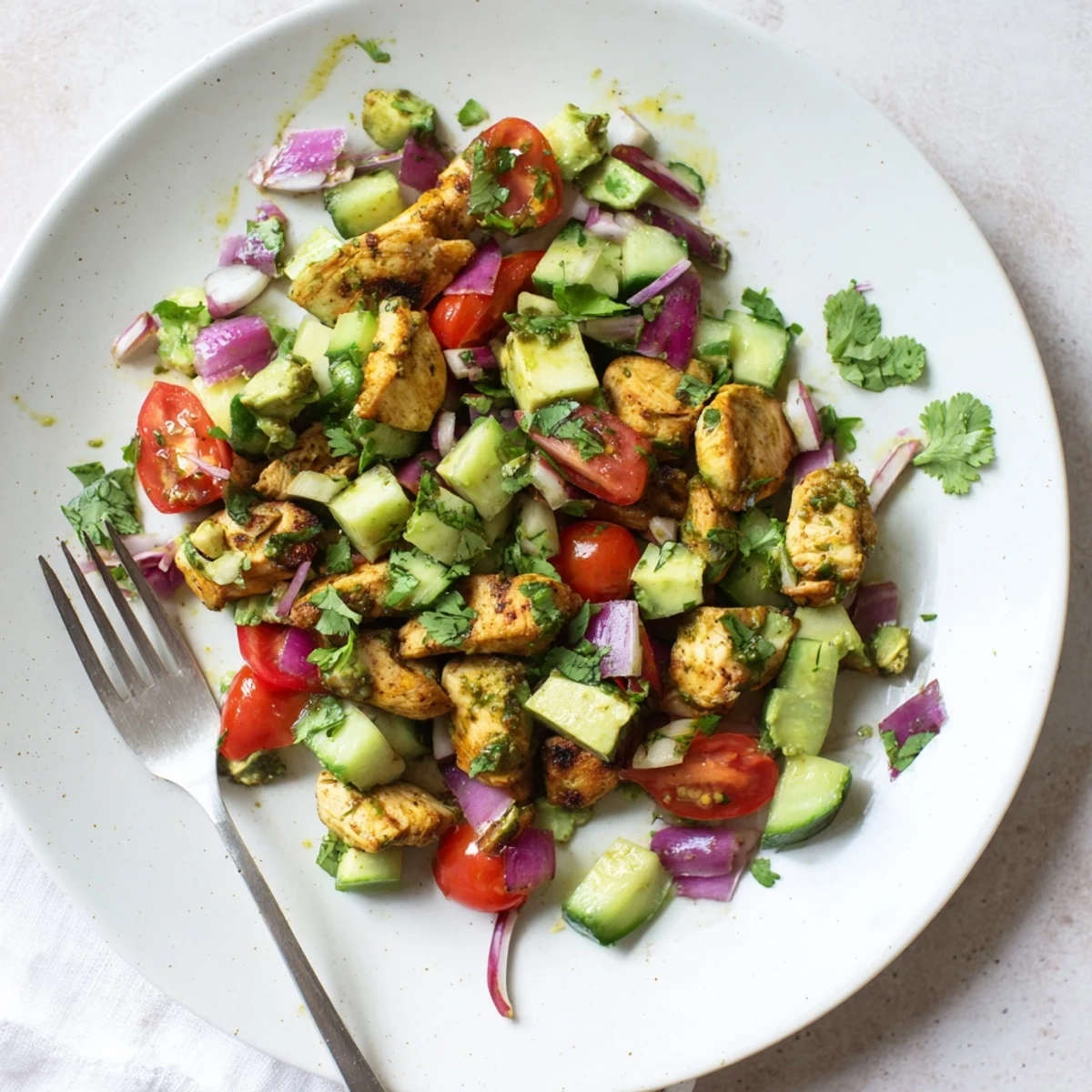Colorful gluten-free healthy avocado chicken salad served with tangy lime dressing and fresh cilantro