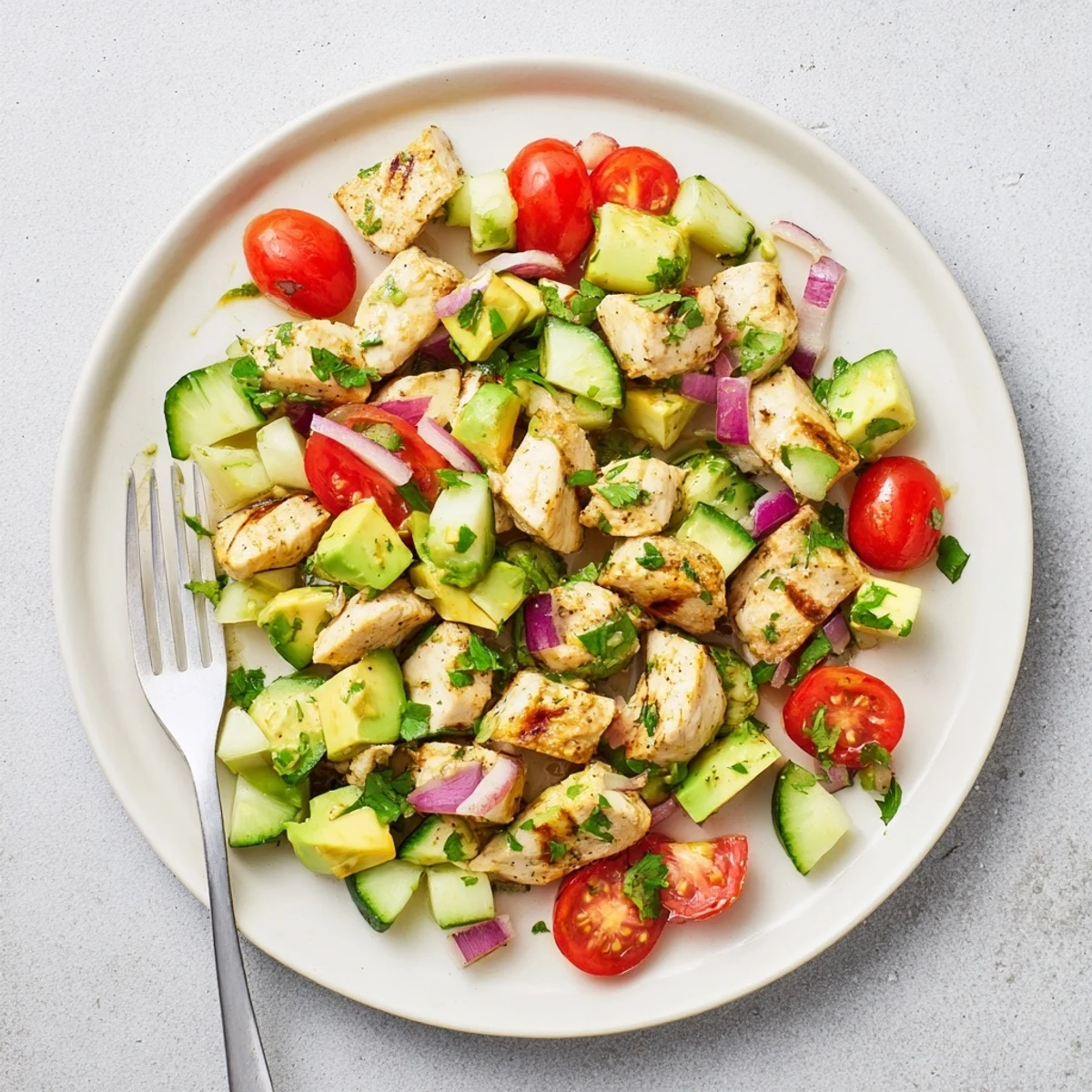 Protein-packed healthy avocado chicken salad featuring juicy diced chicken, ripe avocado, and crisp cherry tomatoes