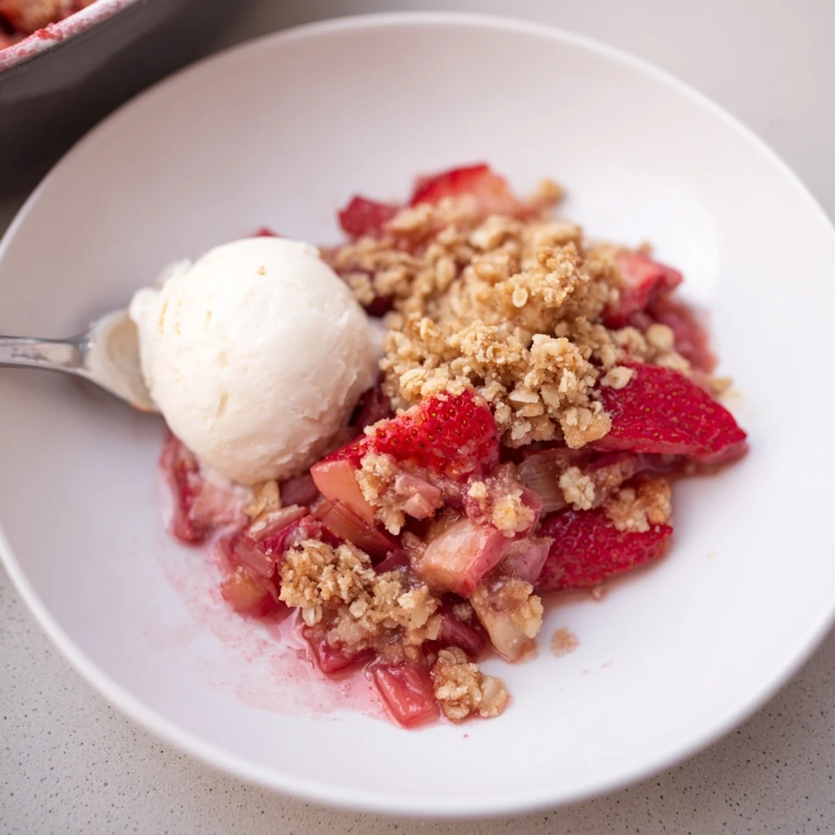 Warm Strawberry Rhubarb Crisp Recipe bubbling with tart fruit and golden oat topping