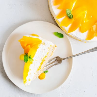 Homemade Mango Mousse Cake with glossy glaze, perfect for summer celebrations and parties.