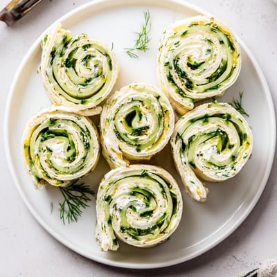 Easy Cucumber And Dill Pinwheels sliced into bite-sized spirals, refreshing party appetizer.