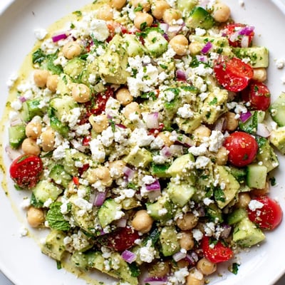 Colorful Chickpea Feta Avocado Salad in a rustic bowl with zesty lemon dressing